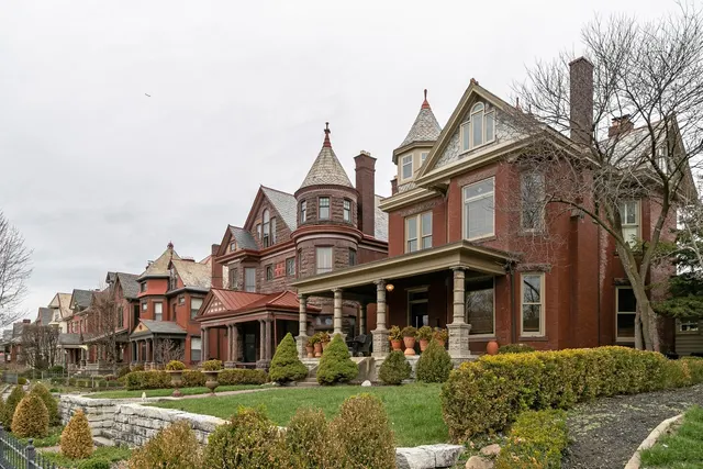Row of large brick Victorian houses with turrets on a street in Columbus, Ohio
